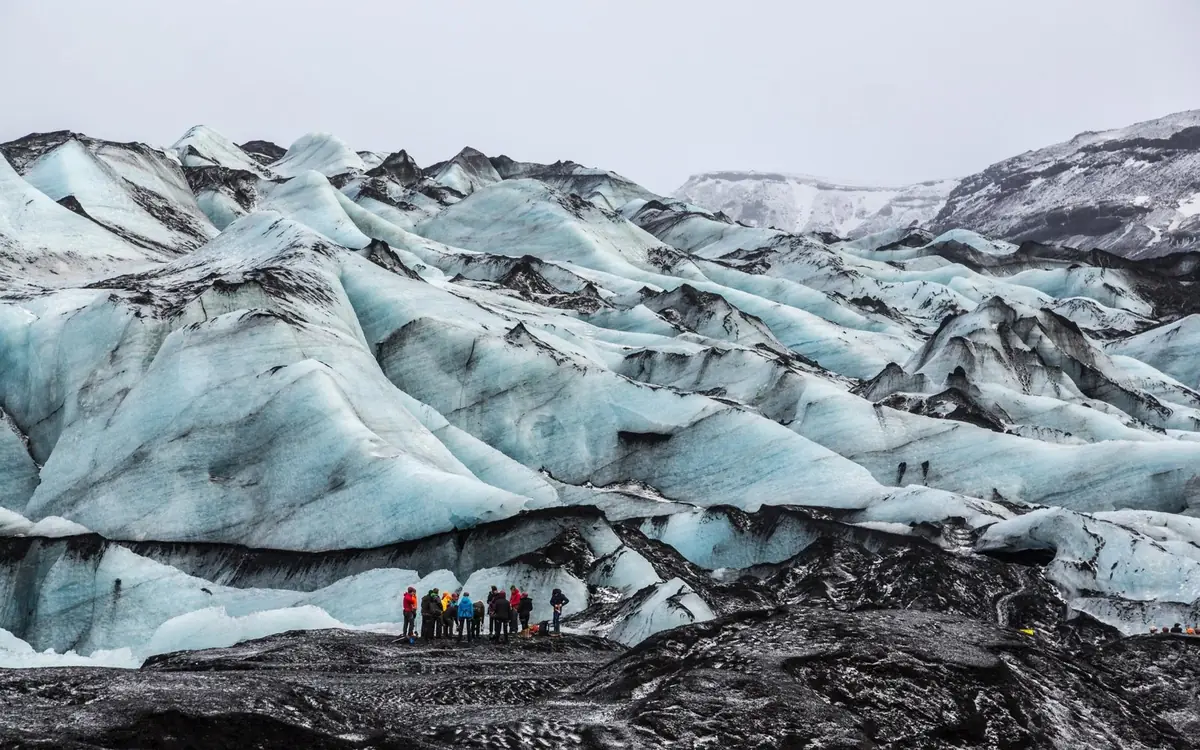 The black ash-streaked surface of Solheimajokull glacier in Iceland