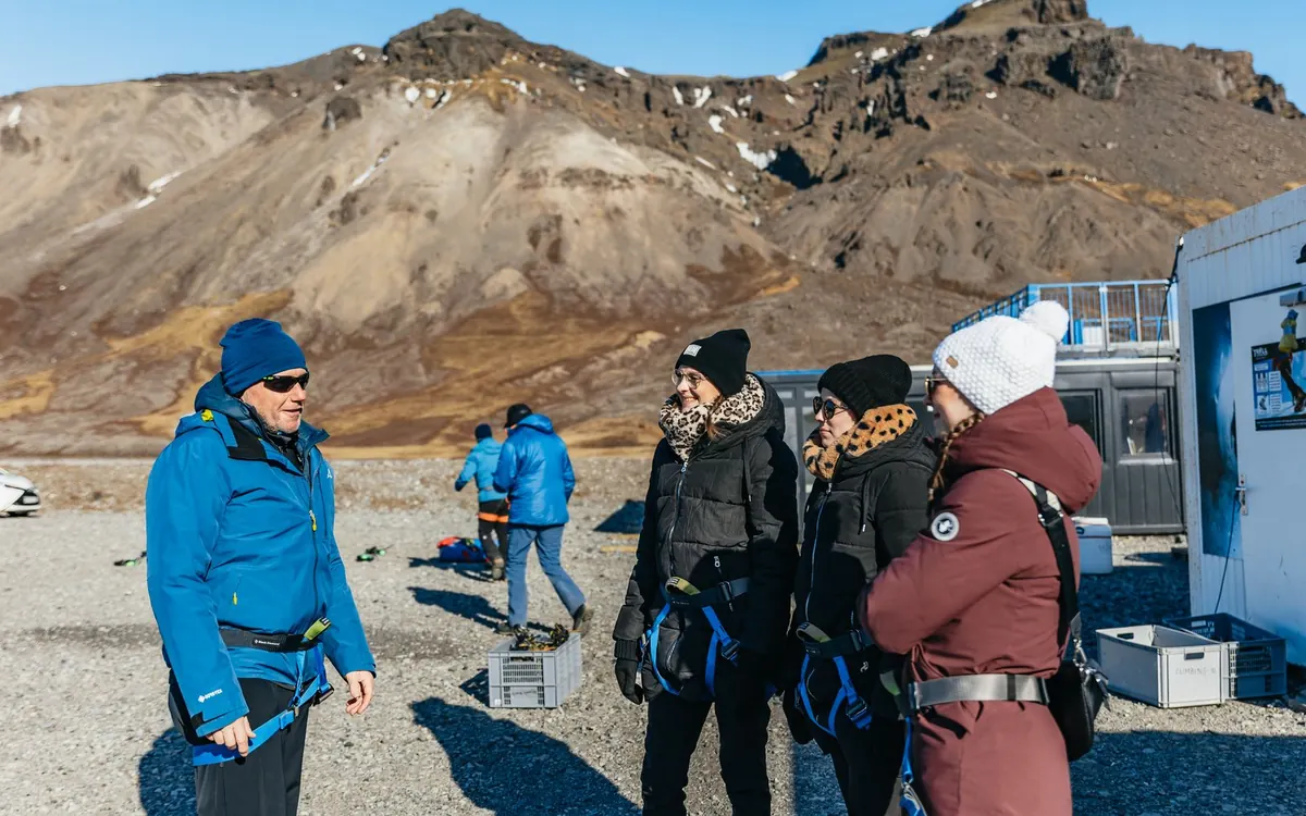 A guide briefing a small group before a glacier walk in Iceland