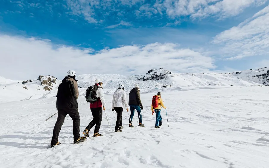 A small group in crampons walking on Falljokull glacier, Iceland