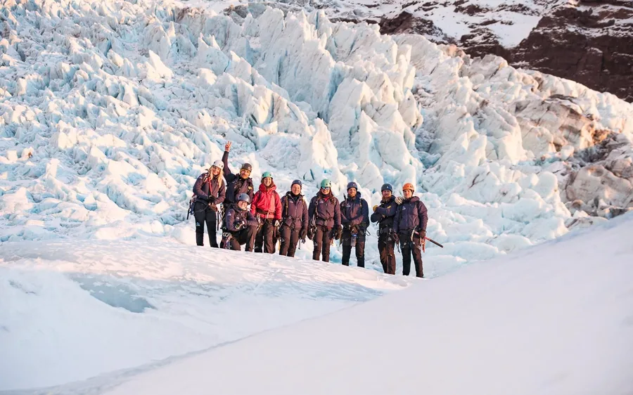 A small group standing on a glacier ridge in Skaftafell, Iceland
