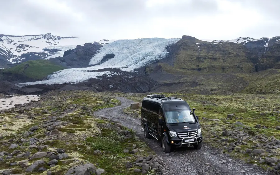 A guide leading a group across the white surface of Vatnajokull, Iceland