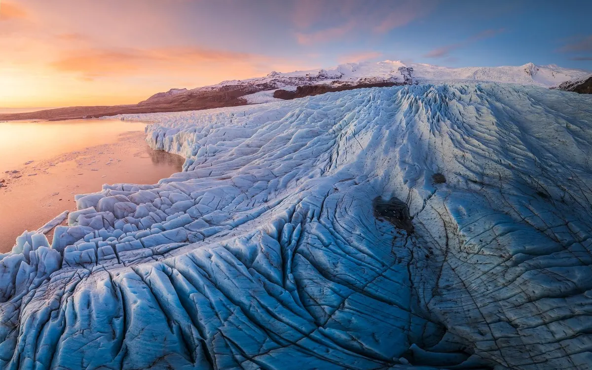 The bare ice of a glacier in Iceland in summer with crevasses exposed